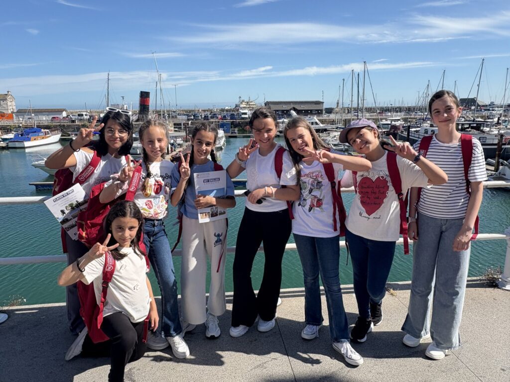 Gruppo di studentesse sul porto turistico, durante una vacanza studio.